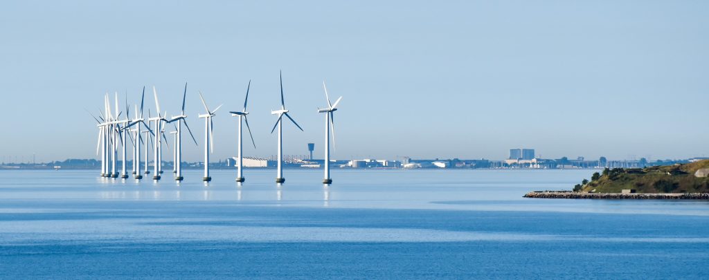 Environmental Toxicology Consulting looking at Offshore wind turbines on the coast of Copenhagen in Denmark with the airport in the background.